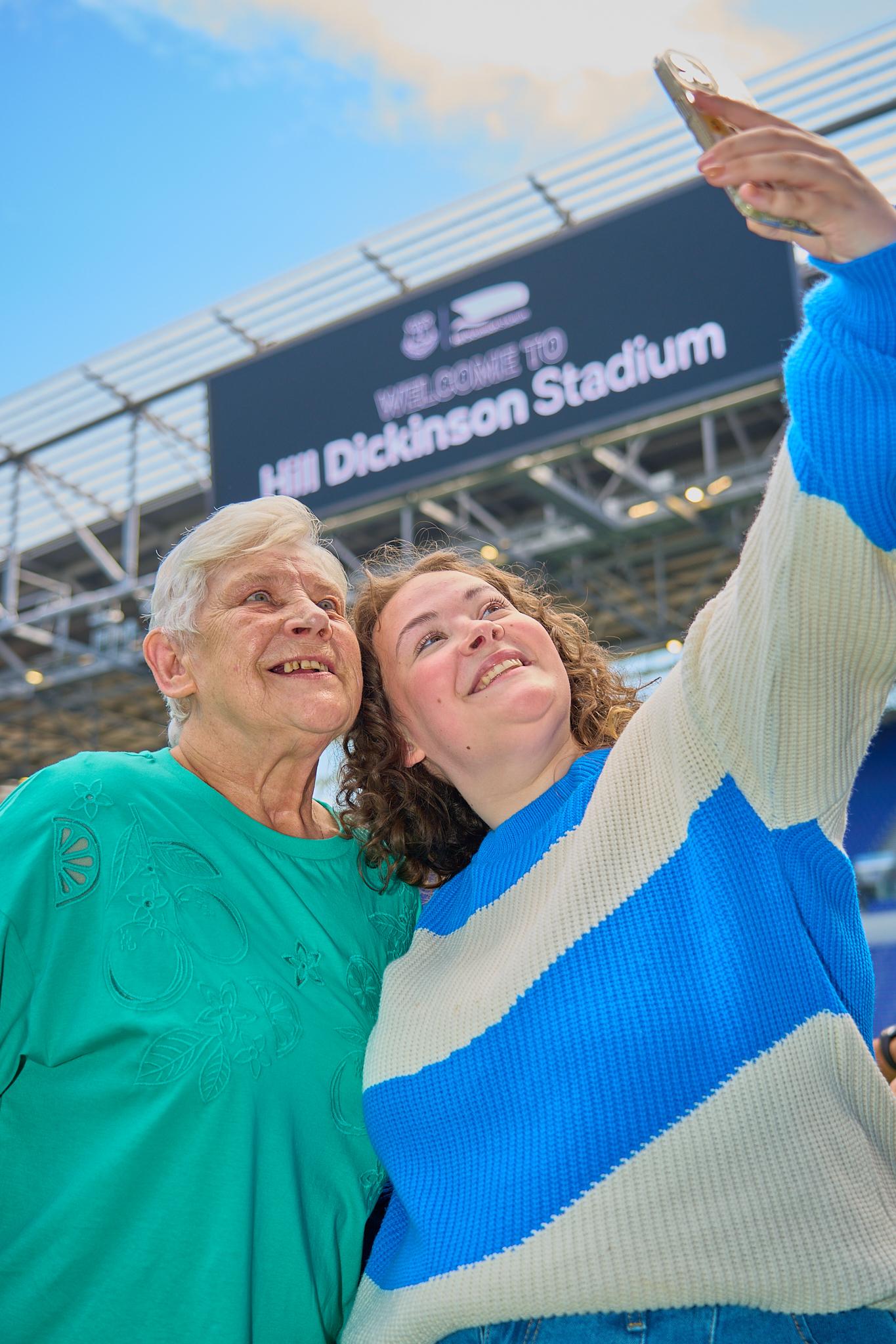 Visitors taking a photograph during an Everton stadium tour at Hill Dickinson Stadium